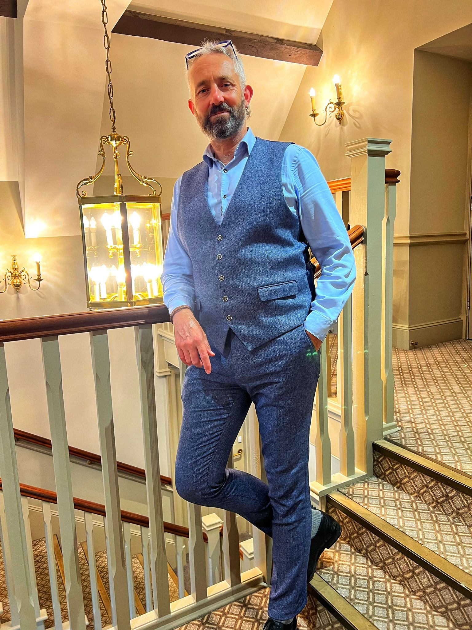 Justin Thomas in suit standing.